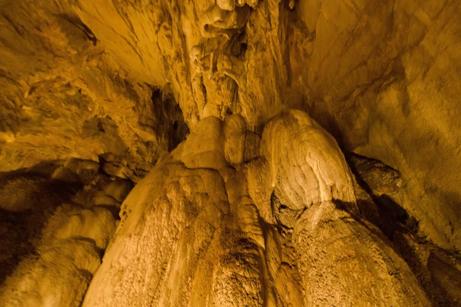 Illuminated flowstone formations inside the Škocjan Caves